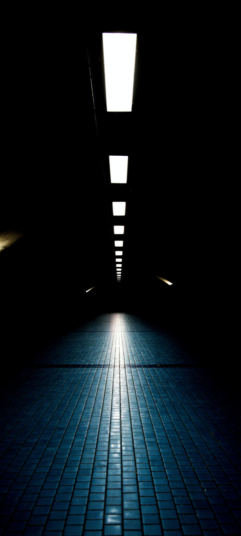 dimly lit walkway with a light