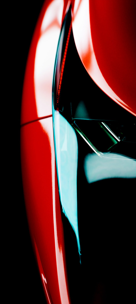close up of red car with shiny hood