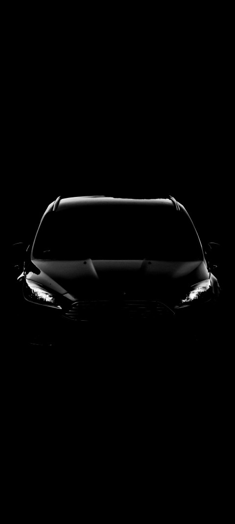 black and white photo of a car in the dark