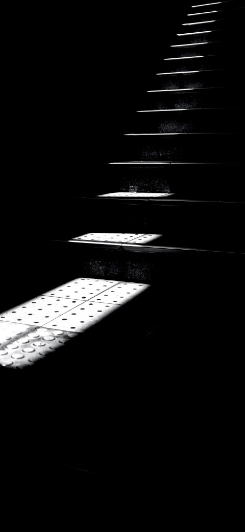 a close up of a staircase with a light coming through it