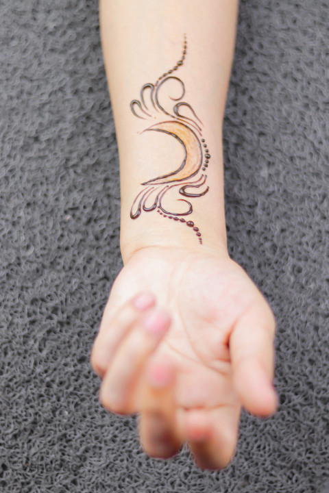 Free photo of Henna wrist moon design