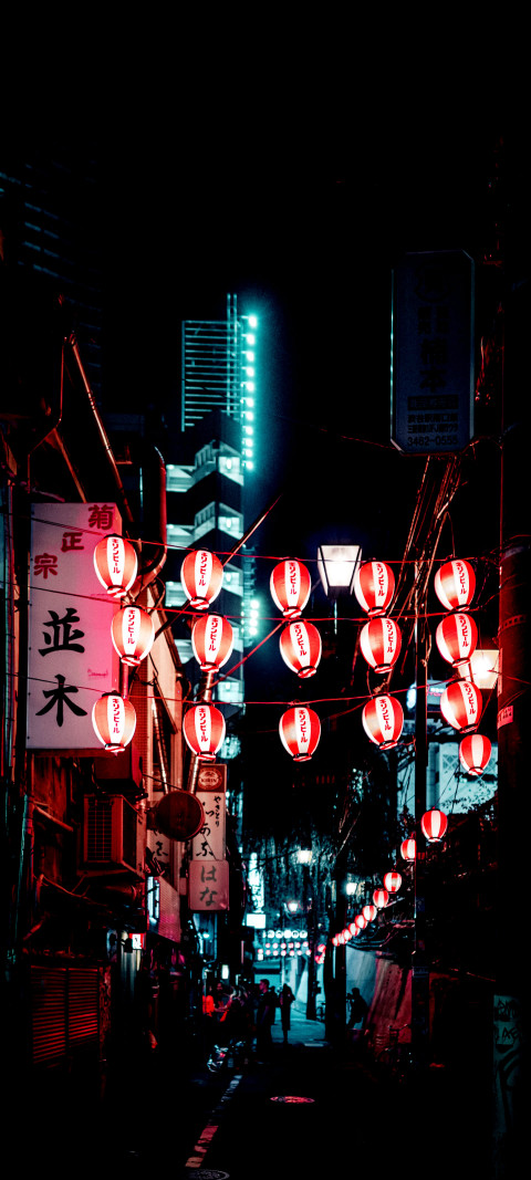 red lanterns hanging from the ceiling of a city street