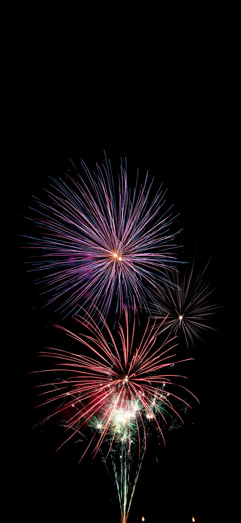 fireworks in the sky with a black background