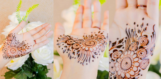 Free photo of Multiangle close up of a hand with henna floral tattoos