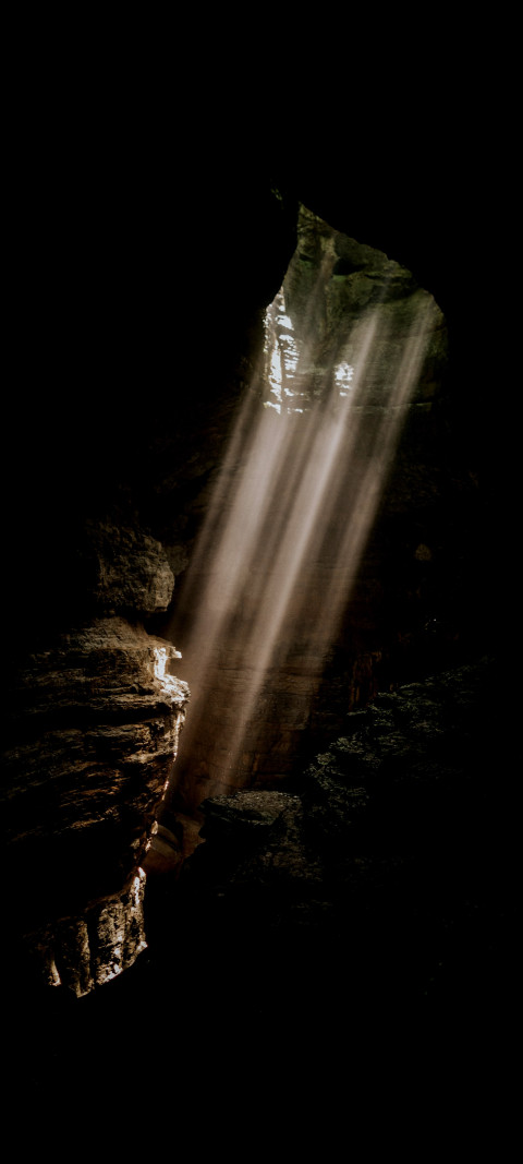 sunlight shining through the sky into a cave