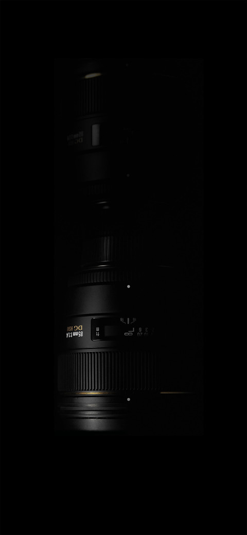 view of a camera lens in the dark with a light on