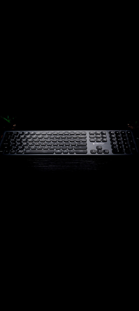 keyboard sitting on a table in dark