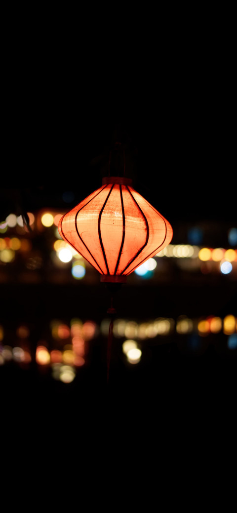 red lantern that is lit up in the dark