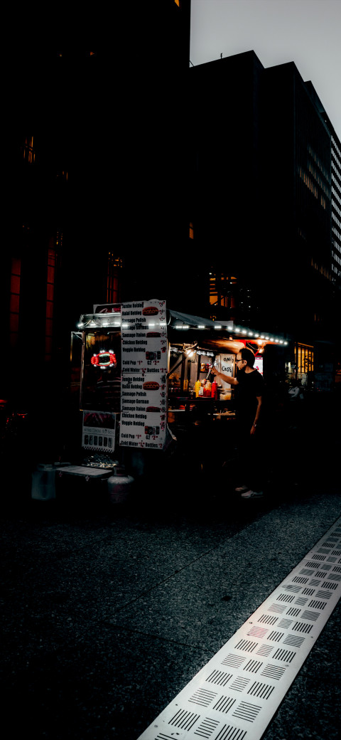 Food truck that is driving down the street at night