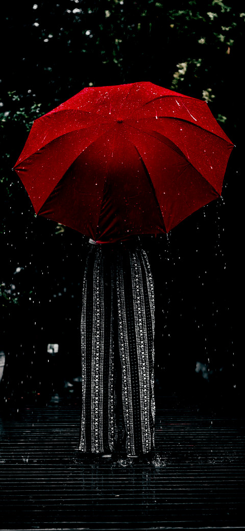 person standing in the rain with an umbrella