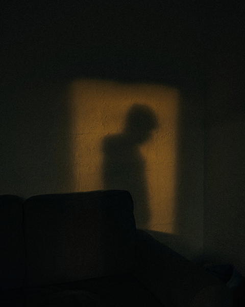 Free photo of shadow of a person standing in a dark room
