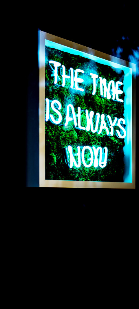neon sign that says the time is always now