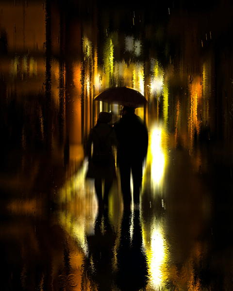 Free photo of two people walking down the street with an umbrella