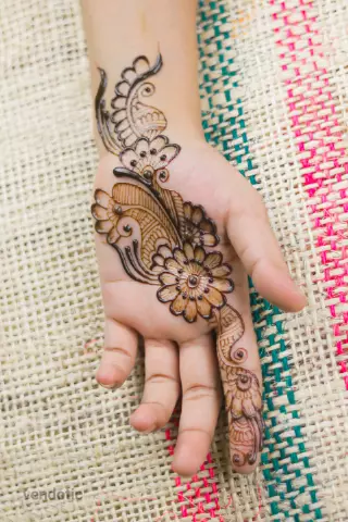 close up of a hand with floral henna
