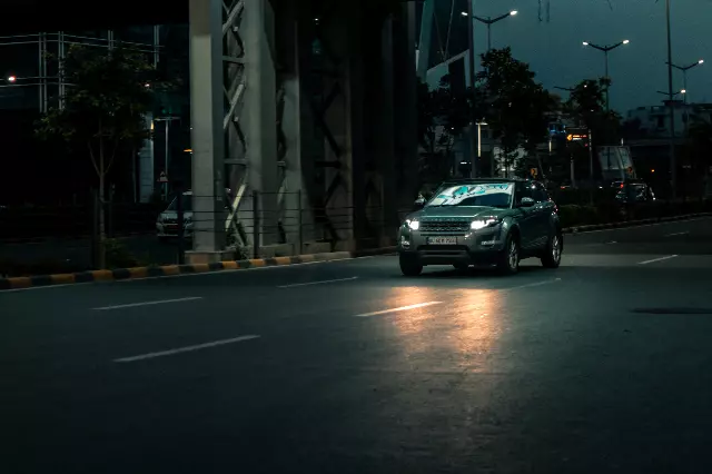 Range Rover Evoque SUV speeding on empty road at dawn