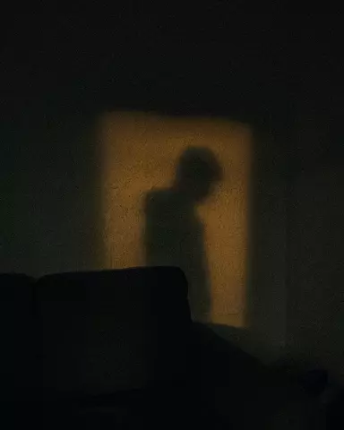shadow of a person standing in a dark room
