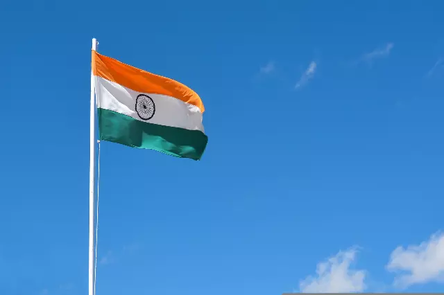 The national flag of India under blue sky