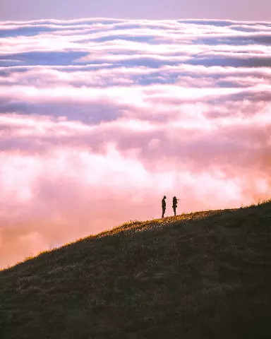 two people on a hill