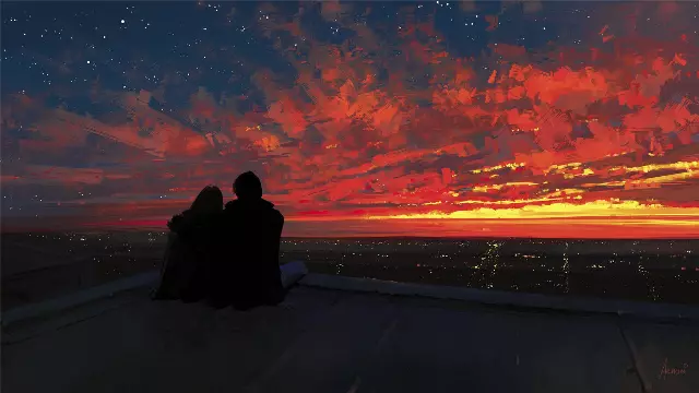 two people sitting on a roof watching the sunset
